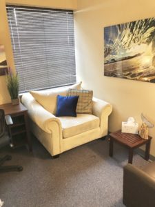 office waiting area warm chairs window blinds wall art