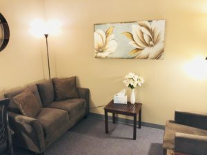 office waiting area warm chairs couch wall art