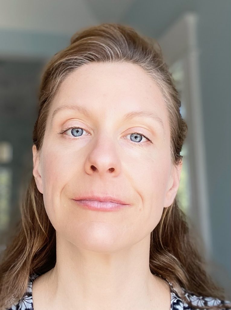 Jennifer Greene with light eyes and long hair, softly smiling.