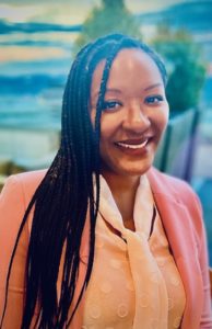 Woman smiling orange attire profile photo