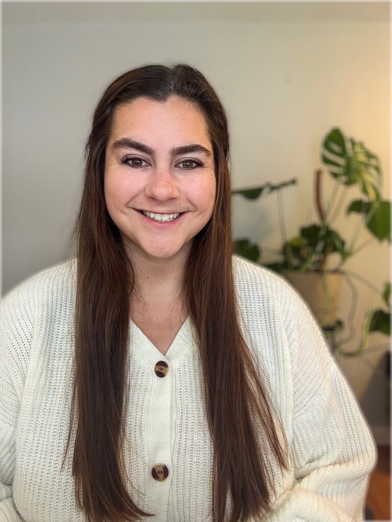 Hannah Bensen, Therapist, Smiling Woman in White Sweater with Long Hair