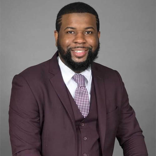 man smiling beard suit tie