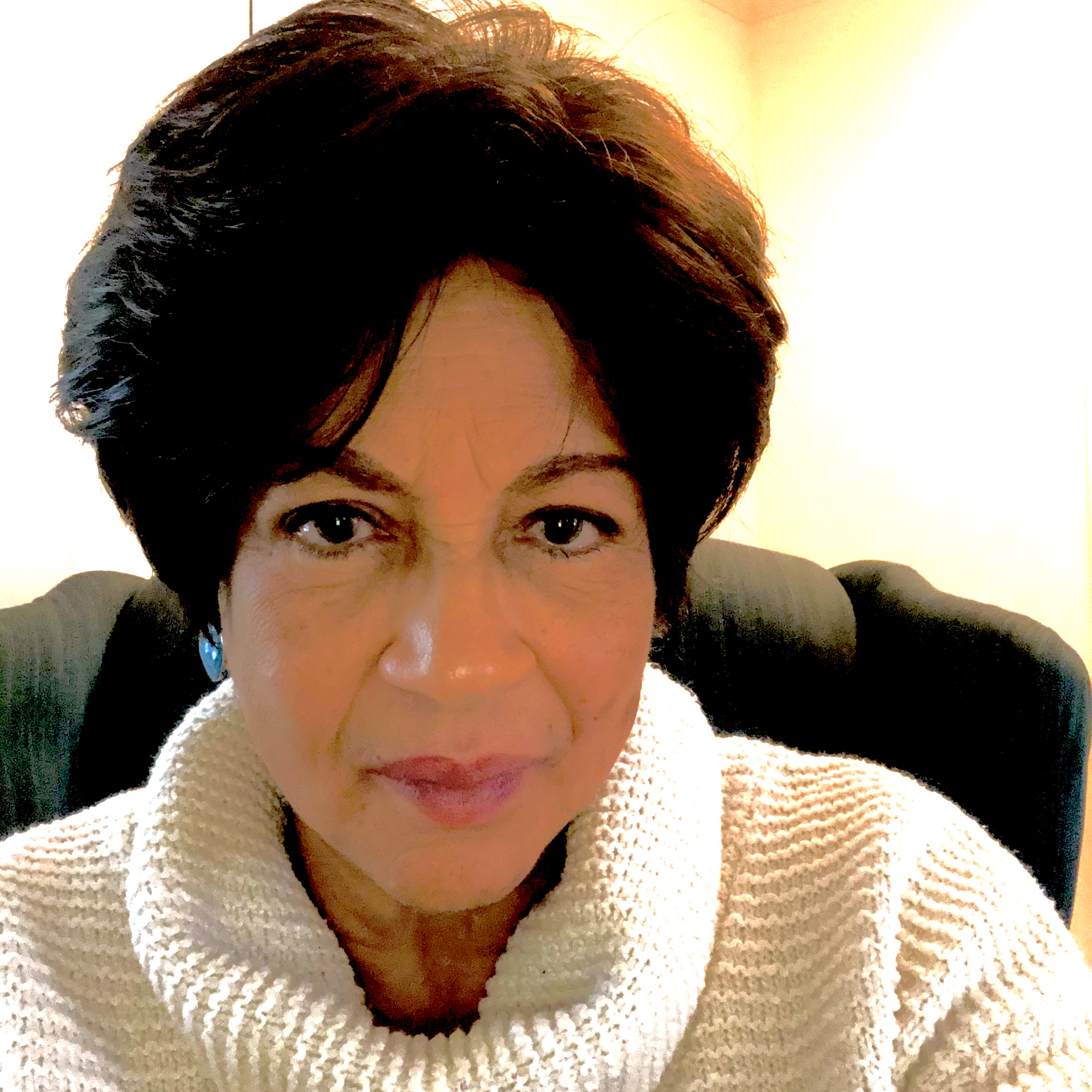 Brenda Hamilton in a white sweater, photographed indoors with a neutral background.